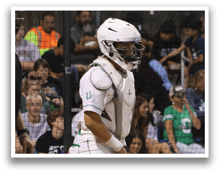 A baseball player wearing a white uniform and a green helmet. Description generated by AI
