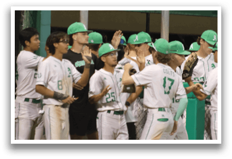 A group of baseball players wearing green hats and white uniforms. Description generated by AI