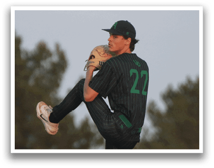 A baseball player in a green and black jersey is pitching a ball. Description generated by AI