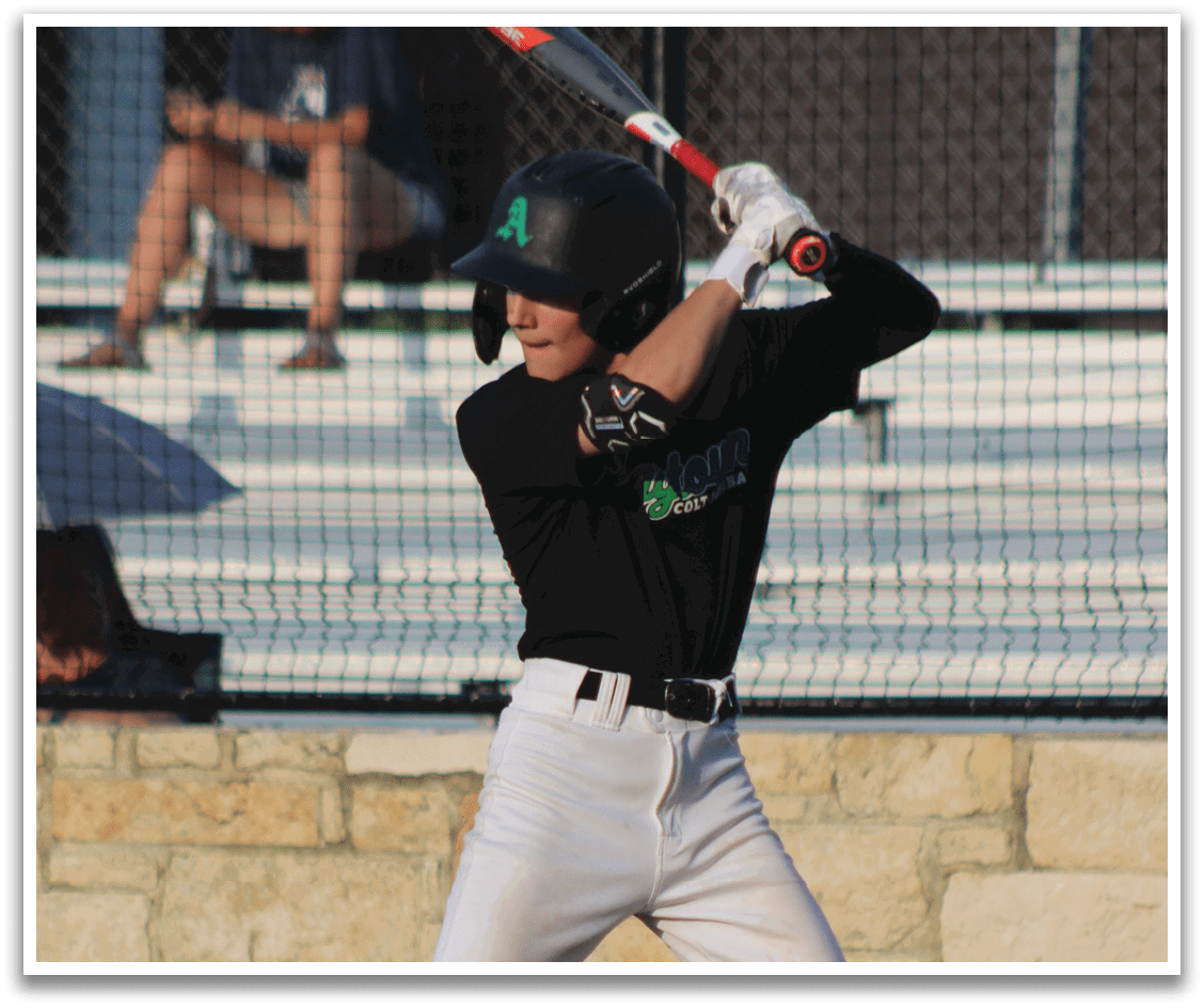 A baseball player in a black and white uniform is swinging a bat on a field. AI generated content