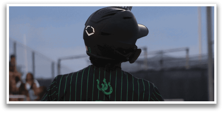 A baseball player wearing a green and white striped shirt. Description generated by AI