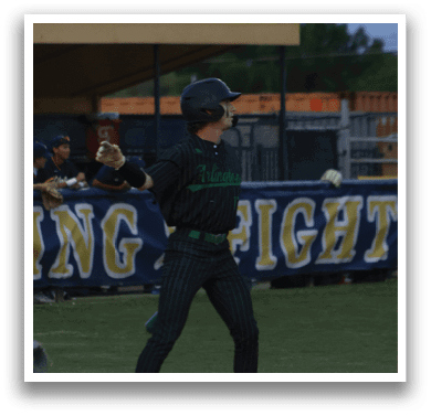 A baseball player in a white uniform is swinging a bat. Description generated by AI
