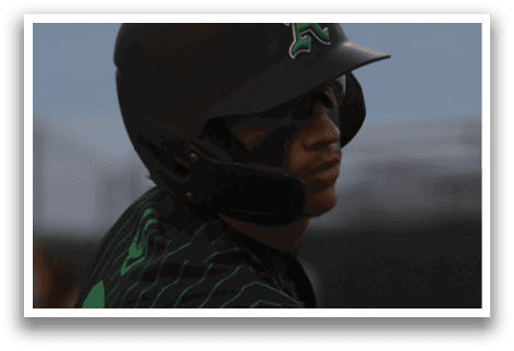 A baseball player wearing a green and black uniform. Description generated by AI