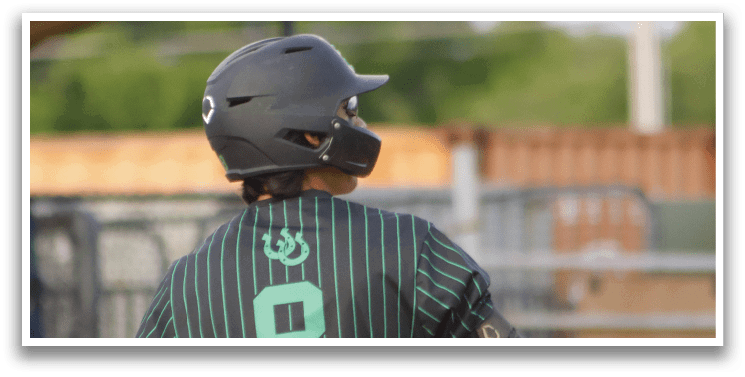A baseball player wearing a green and black striped shirt and a helmet. Description generated by AI