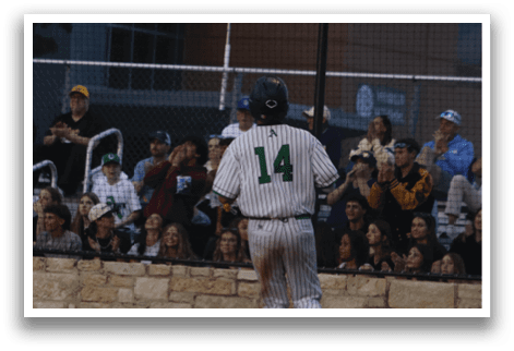 A baseball player wearing a number 14 jersey is running on the field. Description generated by AI