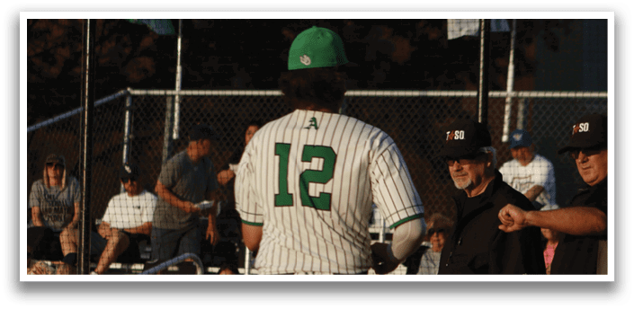 A baseball player wearing a green and white uniform with the number 2 on the back. Description generated by AI