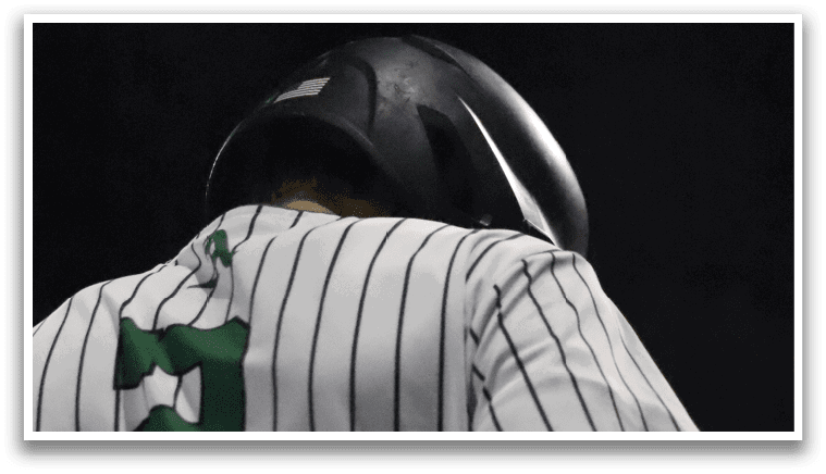 A baseball player wearing a green and white jersey. Description generated by AI