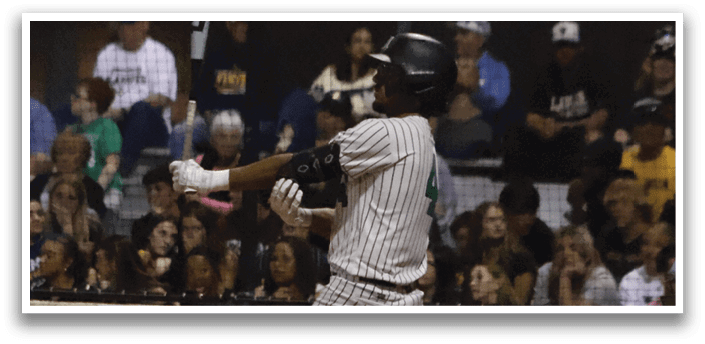 A baseball player is swinging a bat at a ball. Description generated by AI