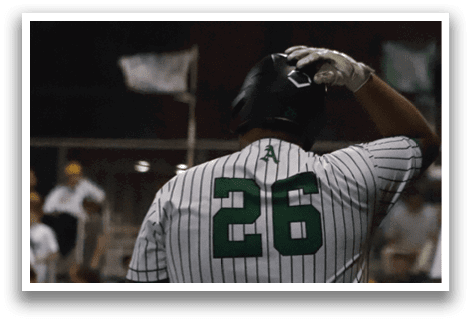 A baseball player wearing a green and white jersey with the number 20 on it. Description generated by AI