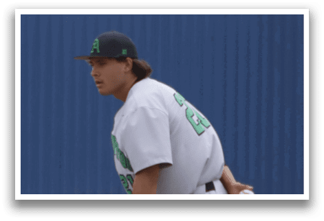 A baseball player in a white uniform is on the field. Description generated by AI