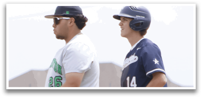 Two baseball players standing on a field. Description generated by AI