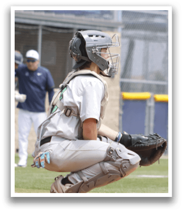 A baseball player is squatting in the dirt. Description generated by AI