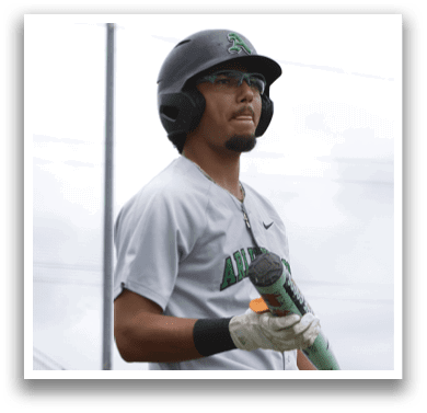 A baseball player wearing a helmet and holding a bat. Description generated by AI