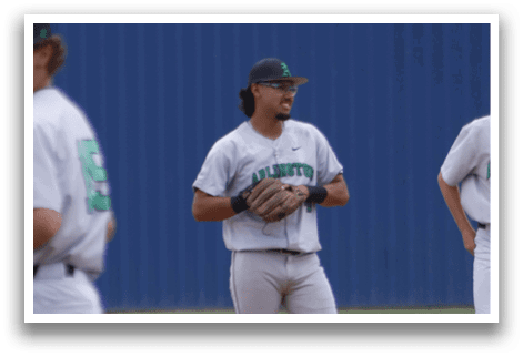 Two baseball players standing on the field. Description generated by AI