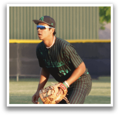 A baseball player in a black and green shirt holding a baseball glove. Description generated by AI