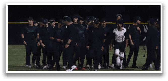 A group of people standing on a field. Description generated by AI