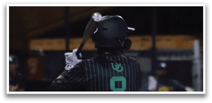 A baseball player wearing a green and black uniform with the number 8 on the back. Description generated by AI