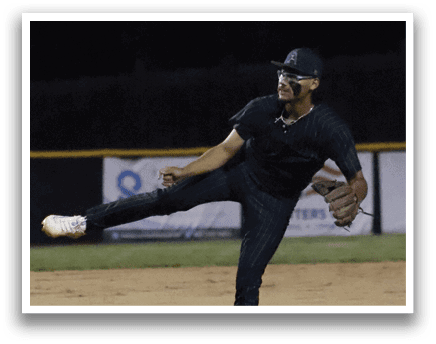 A baseball player in a black shirt and green hat is throwing a ball. Description generated by AI