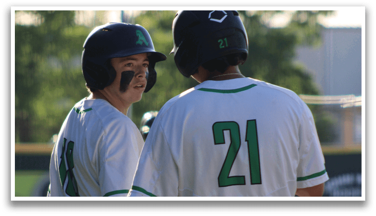 Two baseball players wearing white uniforms and green numbers on their backs. Description generated by AI