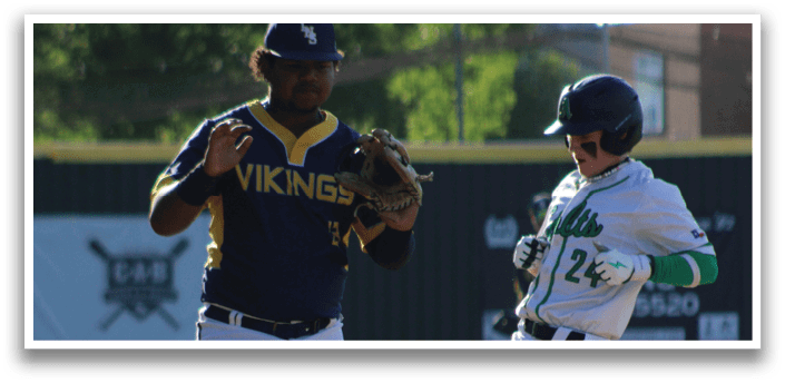 A baseball player in a blue shirt and white pants is walking away from another player. Description generated by AI