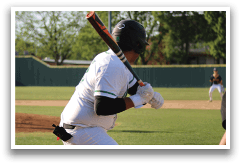 A baseball player in a white uniform is swinging a bat. Description generated by AI