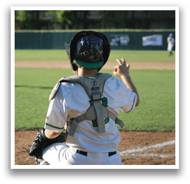 A young boy wearing a baseball uniform and a catcher's mitt. Description generated by AI