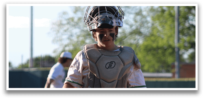 A baseball player wearing a helmet and chest protector. Description generated by AI