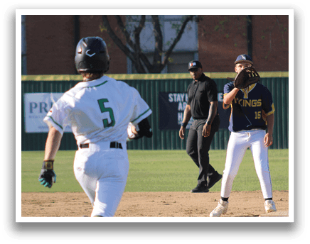 A baseball player wearing a green and white uniform is running to first base. Description generated by AI