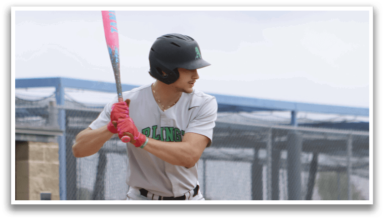 A baseball player in a grey uniform is swinging a bat. Description generated by AI