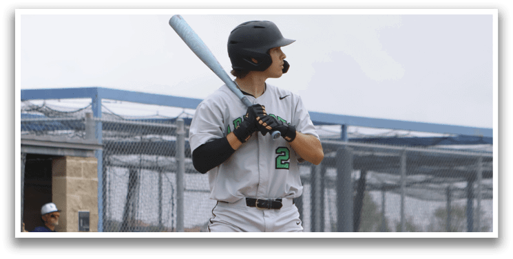 A baseball player is holding a bat and getting ready to swing. Description generated by AI