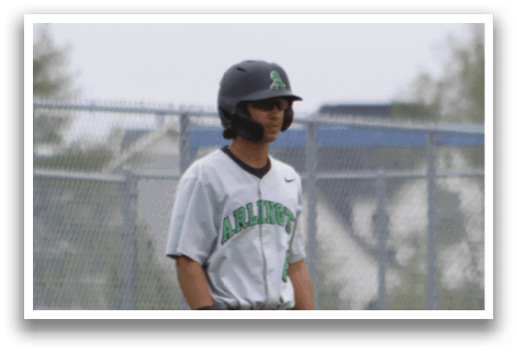 A baseball player wearing a green shirt and black helmet. Description generated by AI