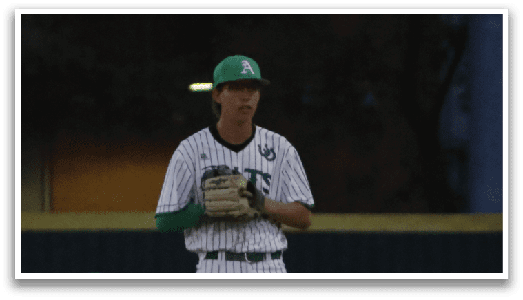 A baseball player wearing a green hat and white uniform. Description generated by AI