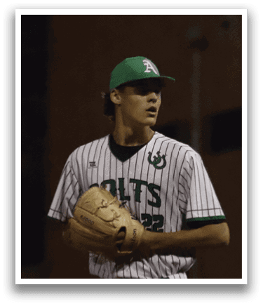 A baseball player wearing a green and white uniform. Description generated by AI