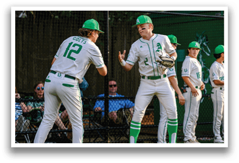 A group of baseball players wearing green and white uniforms. Description generated by AI