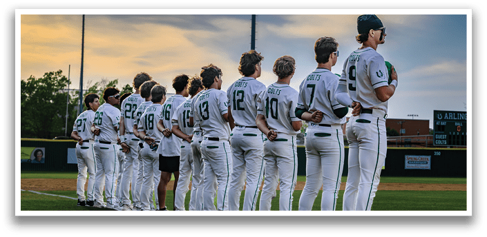 A group of baseball players standing on a field. Description generated by AI