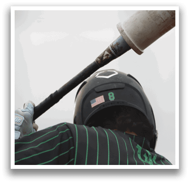 A baseball player wearing a green and black shirt and a black helmet. Description generated by AI