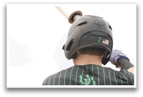 A baseball player wearing a green and black shirt. Description generated by AI