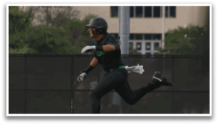 A baseball player running towards a base. Description generated by AI