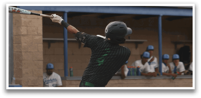 A baseball player in a green and black uniform is swinging a bat. Description generated by AI