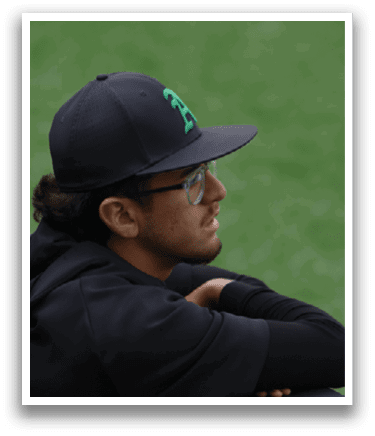 A man wearing a black hat and glasses. Description generated by AI