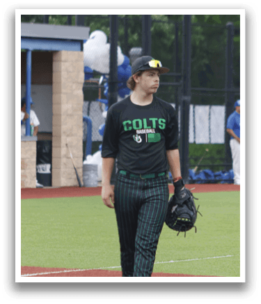 A baseball player wearing a black shirt and green pants. Description generated by AI