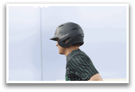 A baseball player wearing a black helmet. Description generated by AI