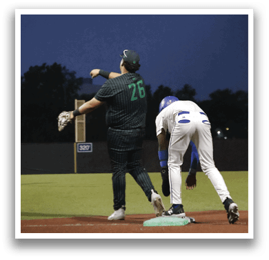 A baseball player is standing on the field with his arms outstretched. Description generated by AI
