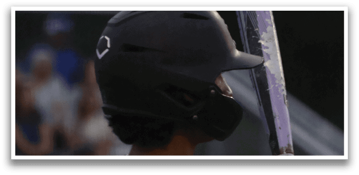 A baseball player holding a bat. Description generated by AI