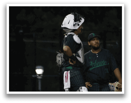 Two men wearing green and white uniforms. Description generated by AI