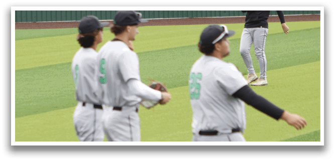 A baseball field with three baseball players standing on it. Description generated by AI