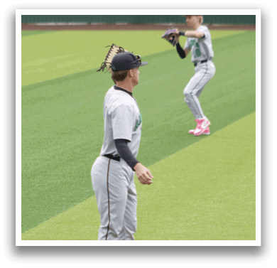 A baseball player wearing a grey uniform and red shoes. Description generated by AI