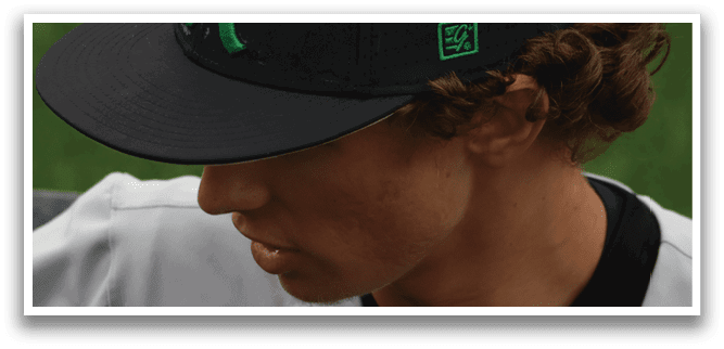 A black and white baseball cap with a green A on it. Description generated by AI