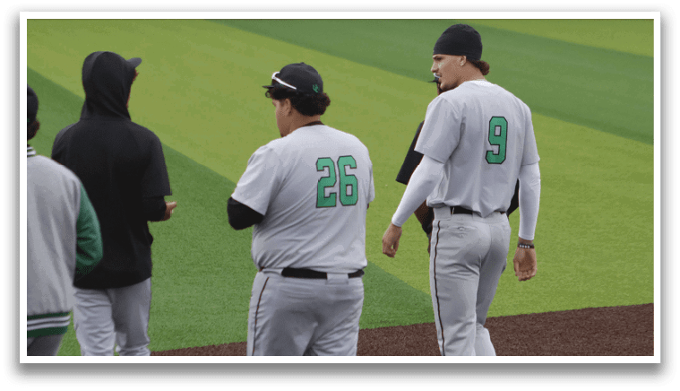 A baseball field with three men standing on it. Description generated by AI