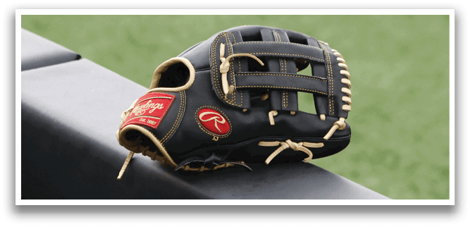 A baseball glove is hanging on a black object. Description generated by AI